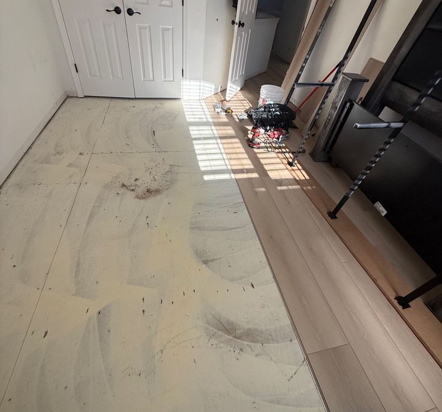 Halfway done: old floor out, new plank going in